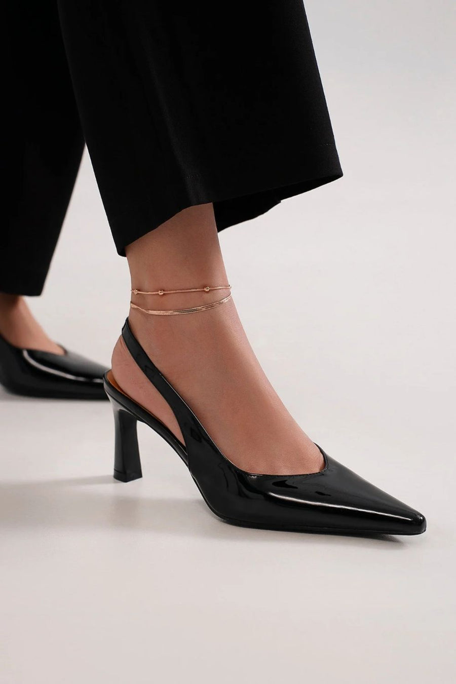 Formal shoes for a long evening gown featuring black pointed-toe slingback pumps