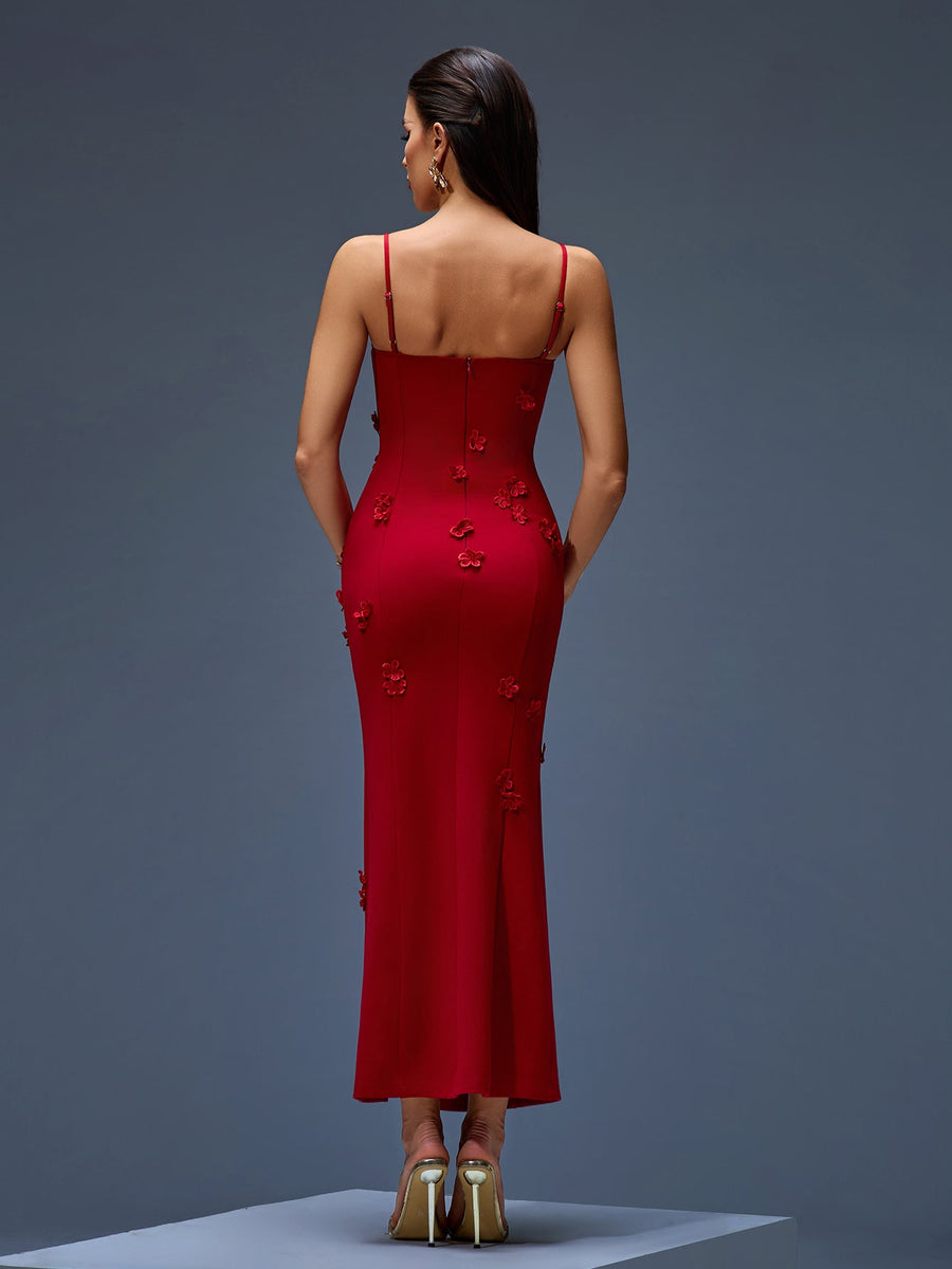 Long flowing dress with a plunging neckline, floral appliqués, and a dramatically high slit
