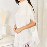 Justin Taylor Turtle Neck Fringe Poncho - Opulent EmpireJustin Taylor Turtle Neck Fringe PonchoOpulent Empire