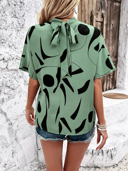 Tied Printed Mock Neck Half Sleeve Blouse - Opulent EmpireTied Printed Mock Neck Half Sleeve BlouseOpulent Empire